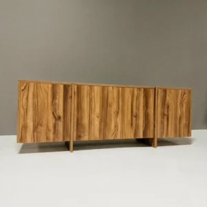 Monsoon Clearbury 6-foot honey-brown TV stand with prominent wood-grain pattern, three broad front panels and raised vertical supports.