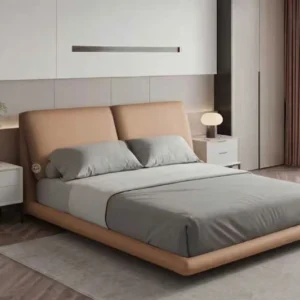 Monsoon Fernmont 5×6 tan upholstered bed with twin reclined padded headboard panels and matching rounded low-profile frame.