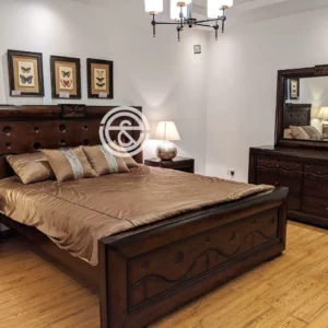 Monsoon Heatherbridge 5×6 dark-brown wooden bed with circular recessed headboard details, decorative carvings and matching raised footboard.
