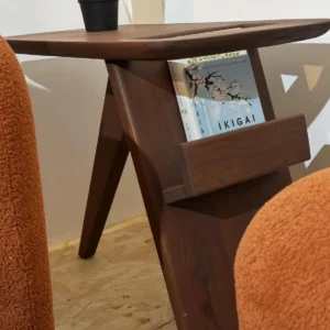 Dark-brown wooden side table with rounded tabletop corners, angled legs and built-in book rack